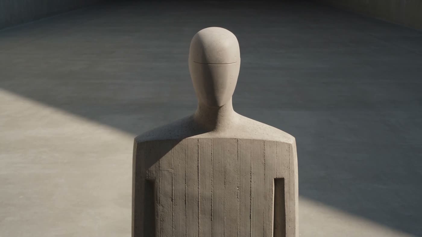 Figura humanoide vaciada en concreto, de pie en una sala del mismo edificio